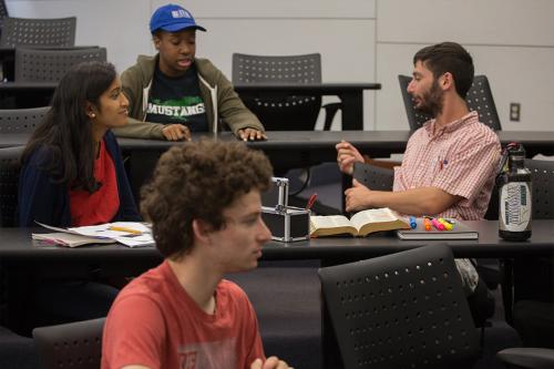 A group of CCAS students discussing in a classroom